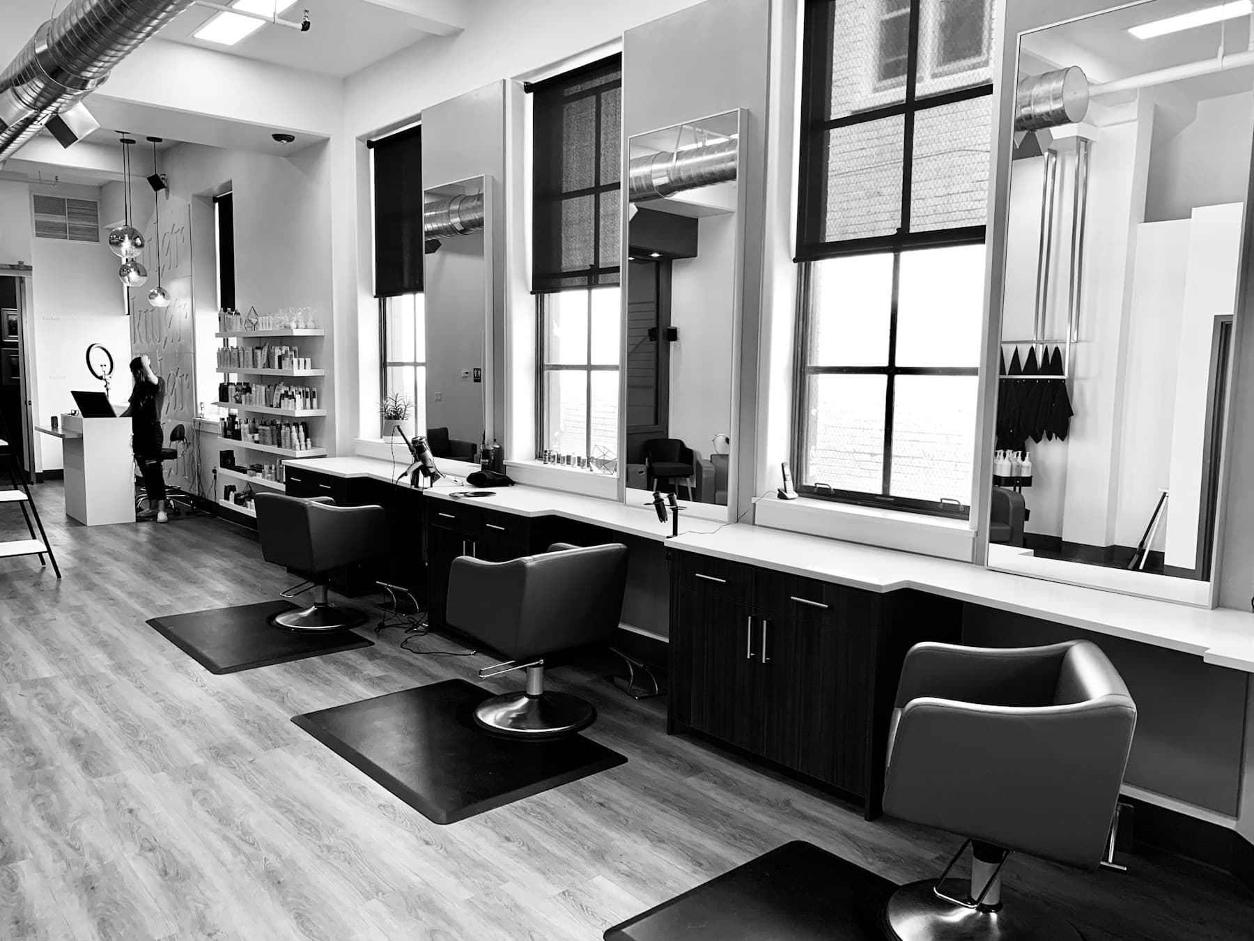 Stylist working with a client in a bright contemporary hair salon